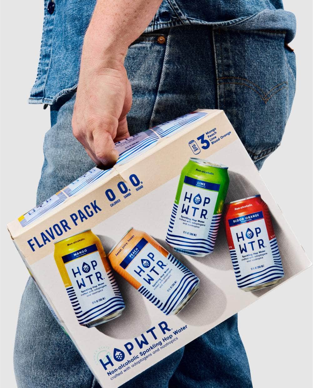 Person carrying a HOPWTR Flavor Pack box